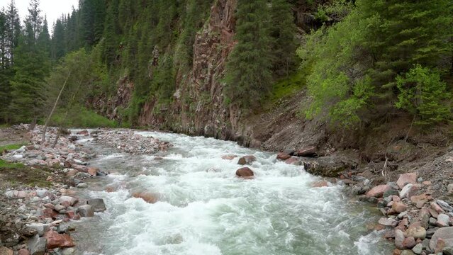 Jeti-Oguz Canyon in Kyrgyzstan is a breathtaking natural wonder, with its flowing river that carves through the rugged landscape, creating a stunning contrast of colors for outdoor enthusiasts.