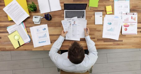 Manager looks through many different resumes and chooses perfect person. Selecting candidate for high paying job