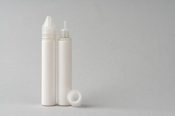 Refill liquid for electronic cigarettes on gray background