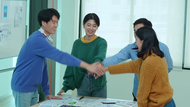 ux developers and ui designers use augmented reality to brainstorm on mobile app and web site page interface wireframe designs on modern office desks. successful, deal, success, together concepts.