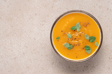 Pumpkin soup puree with spices top view. Comfortable autumn warm food