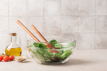 Fresh green lettuce leaves mix in glass bowl. Cooking healthy and delicious food. Diet food concept