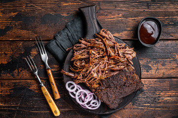 Traditional barbecue wagyu pulled beef on wooden board. Wooden background. Top view - obrazy, fototapety, plakaty