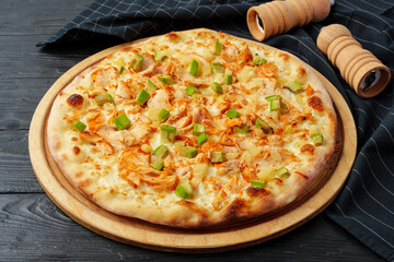 Fresh tasty pizza on black wooden background