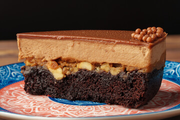 Delicious chocolate cake in white plate on wooden table background