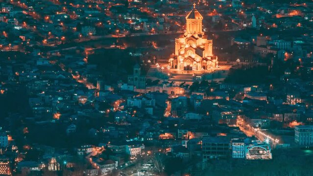 Tbilisi, Georgia. ight Scenic View Of City Center. 4k Hyperlapse Elevated Top Scenic View Famous Landmark Sameba Church In Evening. Georgian Capital Skyline Cityscape Night Time Lapse Timelapse. N
