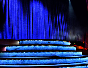 Elegant theater stage with closed blue curtain