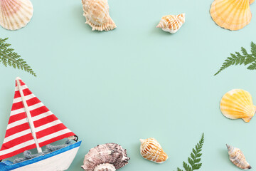 nautical concept seashells and starfish over mint blue wooden background