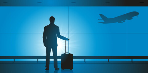 Concept du voyage d’affaires, avec un homme seul qui attend seul à l’aéroport avant d’embarquer dans un avion. - obrazy, fototapety, plakaty