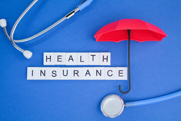 stethoscope and umbrella with the alphabet word Health insurance. health insurance concept 