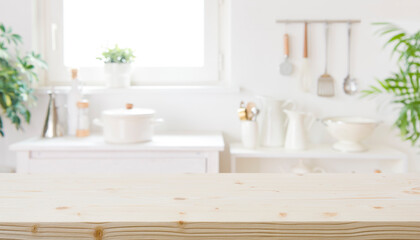 Obraz na płótnie Canvas Blurred modern kitchen furniture interior with wooden table in front