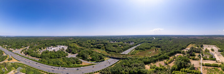 Fototapeta na wymiar 180 panorama with wildlife crossing green corridor bridge for animals to migrate between conservancy areas over Dutch interstate highway. Engineering aerial environment nature reserve infrastructure