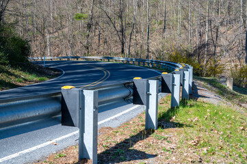 Closeup of guard rail going around a curve on a country road