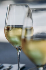 Two glasses of white wine, partially out of focus