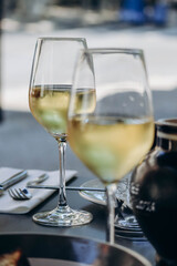 Two glasses of white wine, partially out of focus