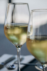 Two glasses of white wine, partially out of focus