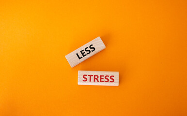 Less stress symbol. Wooden blocks with words Less stress. Beautiful orange background. Healthcare and Less stress concept. Copy space.