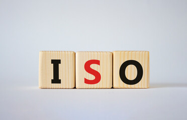 ISO standards quality control symbol. Concept word ISO on wooden cubes. Beautiful white background. Business and ISO concept. Copy space.