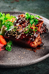 grilled meat ribs with vegetables on plate
