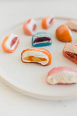 Mochi. Traditional Japanese dessert. Rice cake with filling. Bright original dessert. Sweetness. The filling is shown.