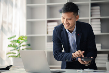 Man in the office, he is young businessman, modern business management, start-up company run by young people, modern entrepreneur with new ideas. to be a business leader. Startup company concept.