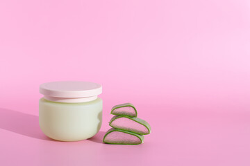 Cosmetic cream and aloe vera slices, copy space