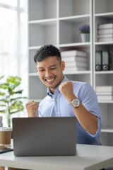 The businessman is doing a happy gesture after looking at the sales summary and as expected, he has...