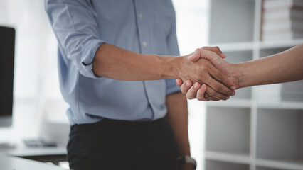 Obraz na płótnie Canvas Business investor group holding hands, Two businessmen are agreeing on business together and shaking hands after a successful negotiation. Handshaking is a Western greeting or congratulation.