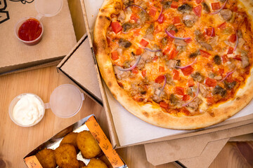 Flatlay with Pizza , sauces and nuggets are arranged on the table. High quality photo. 6 October 2022. Russia