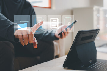 Businessman working on laptop computer with electronics document icons, E-document management,...