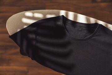 Black t-shirt mockup, template on ironing board