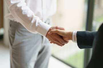 Fototapeta premium Businessman shaking hands successful making a deal. mans handshake. Business partnership meeting concept