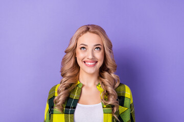 Photo of cute lady look up empty space read good news low prices store wear plaid shirt isolated pastel color purple background