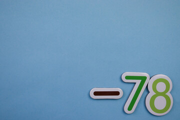Colorful number -78, placed on the edge of a blue background.