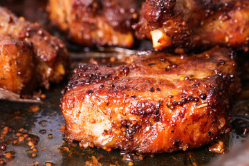 Grilled pork ribs on slate board close-up.