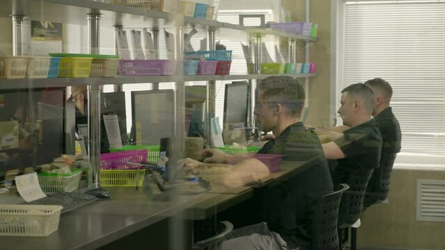 Dental laboratory specialists working on computers. Dental laboratory specialists researching the creation of replacement teeth. Dental laboratory specialists studying the 3D jaw models.