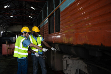 Railway engineering team Wear your safety gear and helmet under inspection under the wheels and controls to ensure the safety of the train. train maintenance.