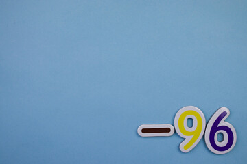 The number -96, written in color, placed on the edge of a blue background.