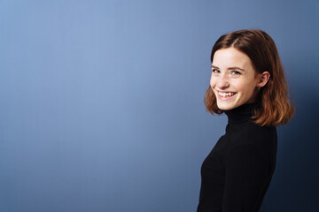 happy young woman with blue background and copy space