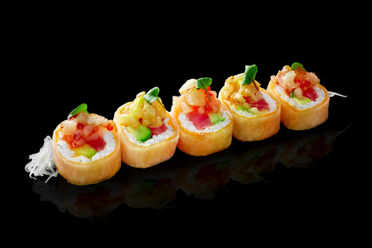 Sushi rolls in mamenori with salmon, tuna, avocado and sea scallop