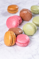 Cake macaron or macaroon on marble background from above, colorful almond cookies, pastel colors, vintage card, top view