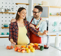 woman couple man pregnant food healthy juice fruit kitchen pregnancy happy love fresh diet mother...