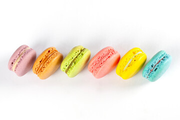 Colorful macarons close up on white background