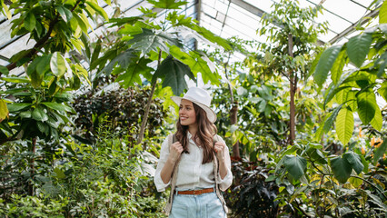 Portrait of young woman in botanical garden.