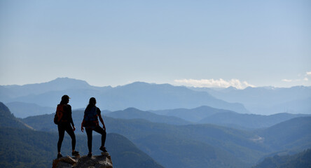 Two Adventurers Watching the Spectacular View from the Peak