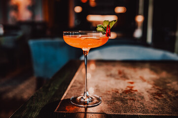 alcohol cocktail in a glass stands on a table in a bar or restaurant