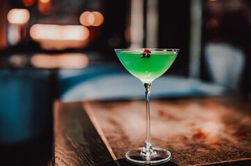alcohol cocktail in a glass stands on a table in a bar or restaurant