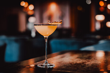 alcohol cocktail in a glass stands on a table in a bar or restaurant