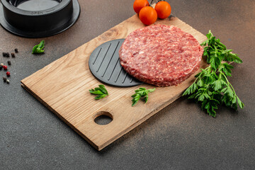 Raw steak cutlets from minced beef meat on a wooden board, Long banner format. top view