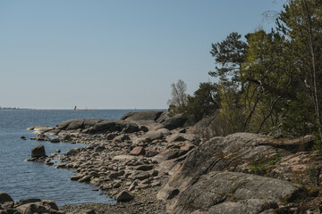 Fototapeta na wymiar Helsinki archipelago island Pihlajasaaren with woods, trees, rocky sandy beaches and spectacular bay views of downtown skyline and other channel islands with beautiful serene nature landscape scenery